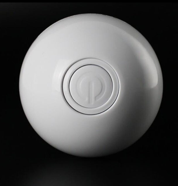 White LED cat ball toy with power button, front view on black background
