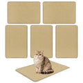 Six sisal scratching mats laid out with a cat sitting on the floor mat, alternate angle