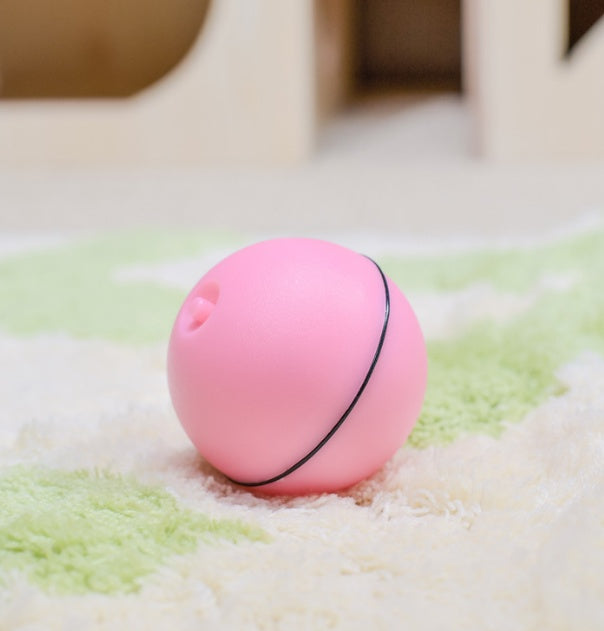 Pink LED ball toy rolling on a shag rug