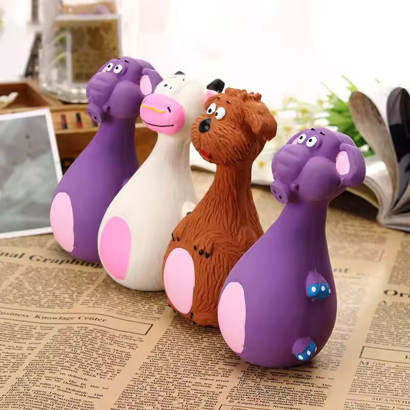 Close-up of the four latex chew toy animal shapes standing together on a newspaper background