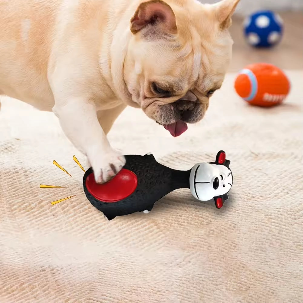 Bulldog pressing a squeaky toy on the floor near other dog toys