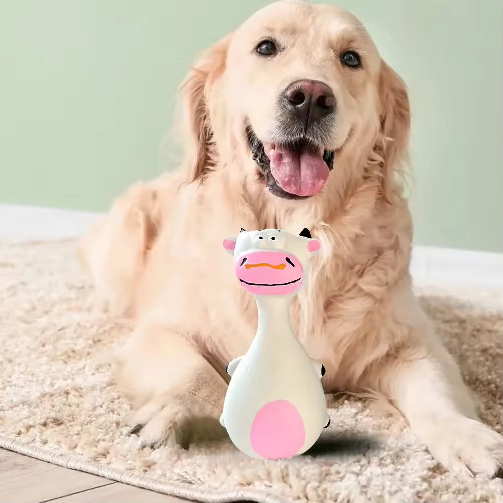 Golden retriever lying with the white cow-shaped latex chew toy