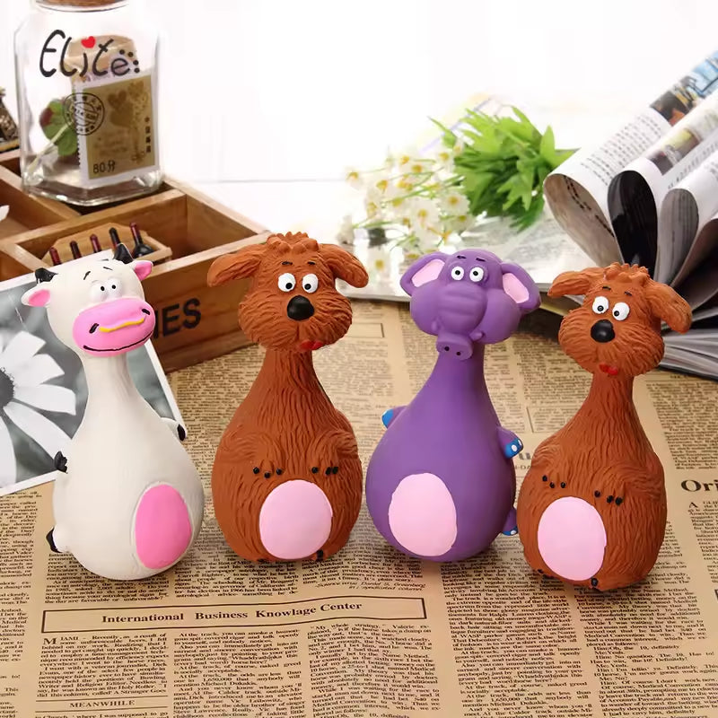 Four latex chew toy animal shapes: cow, bear, elephant, and dog, on a newspaper background